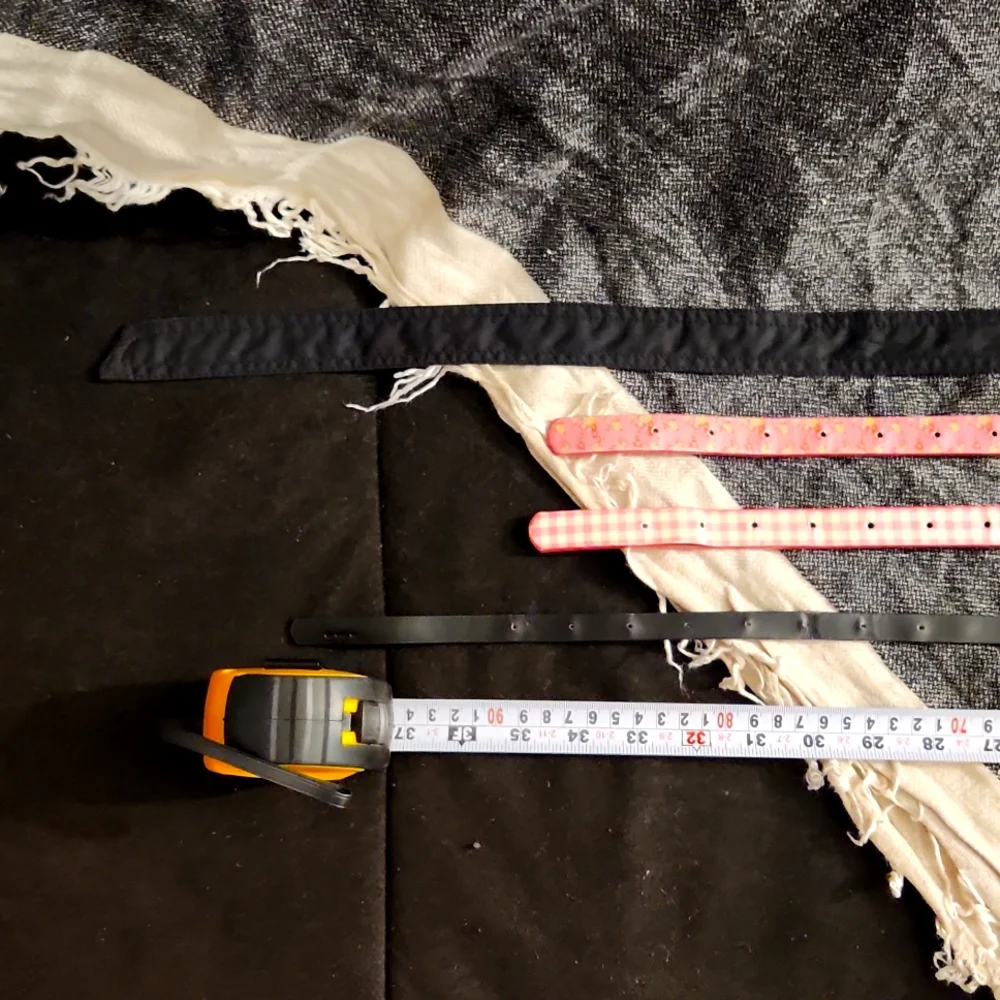 4 used belts printed pink and solid black